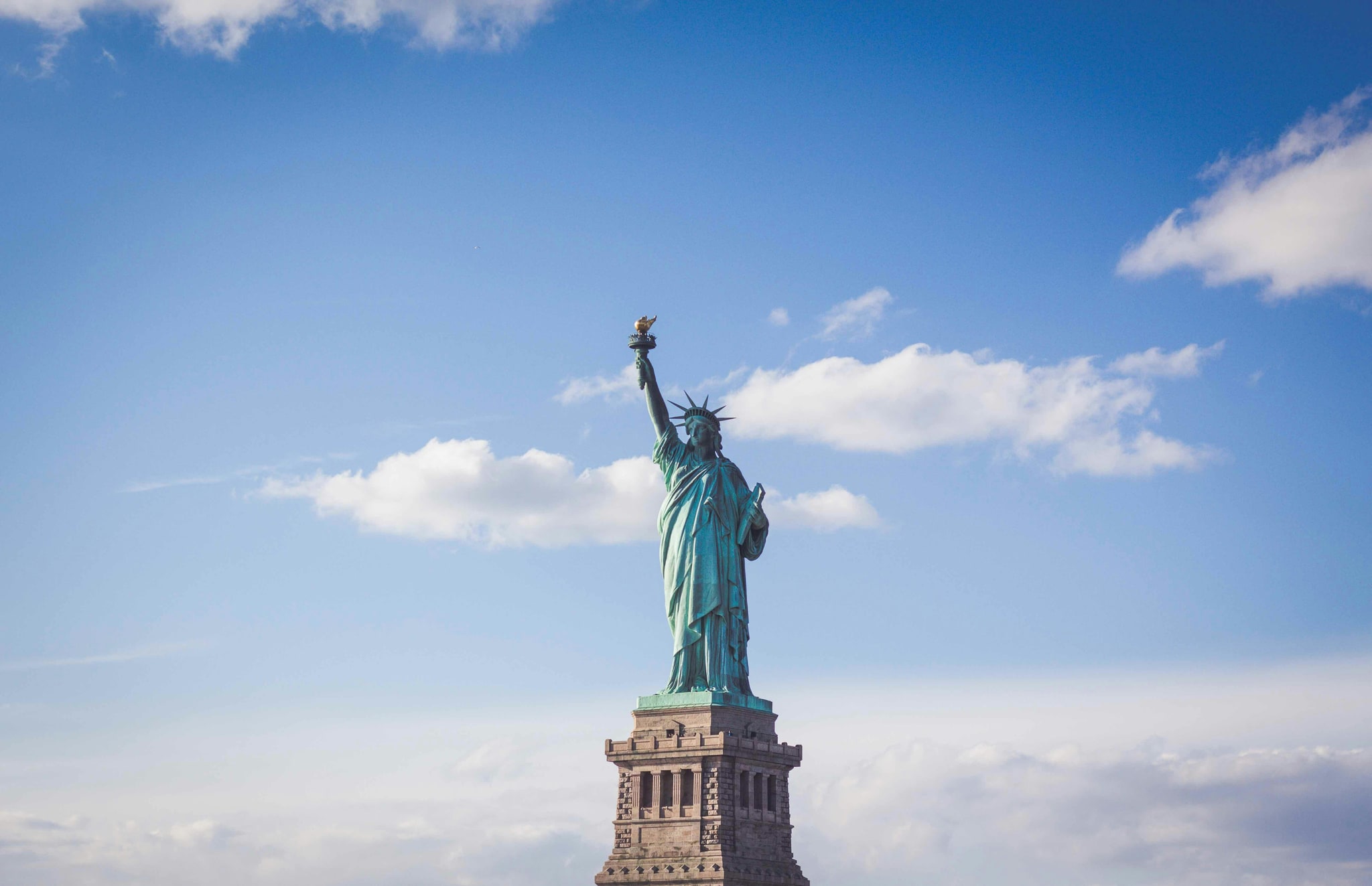American flag against an open sky, celebrating America's 250th anniversary and the spirit of American Dynamism